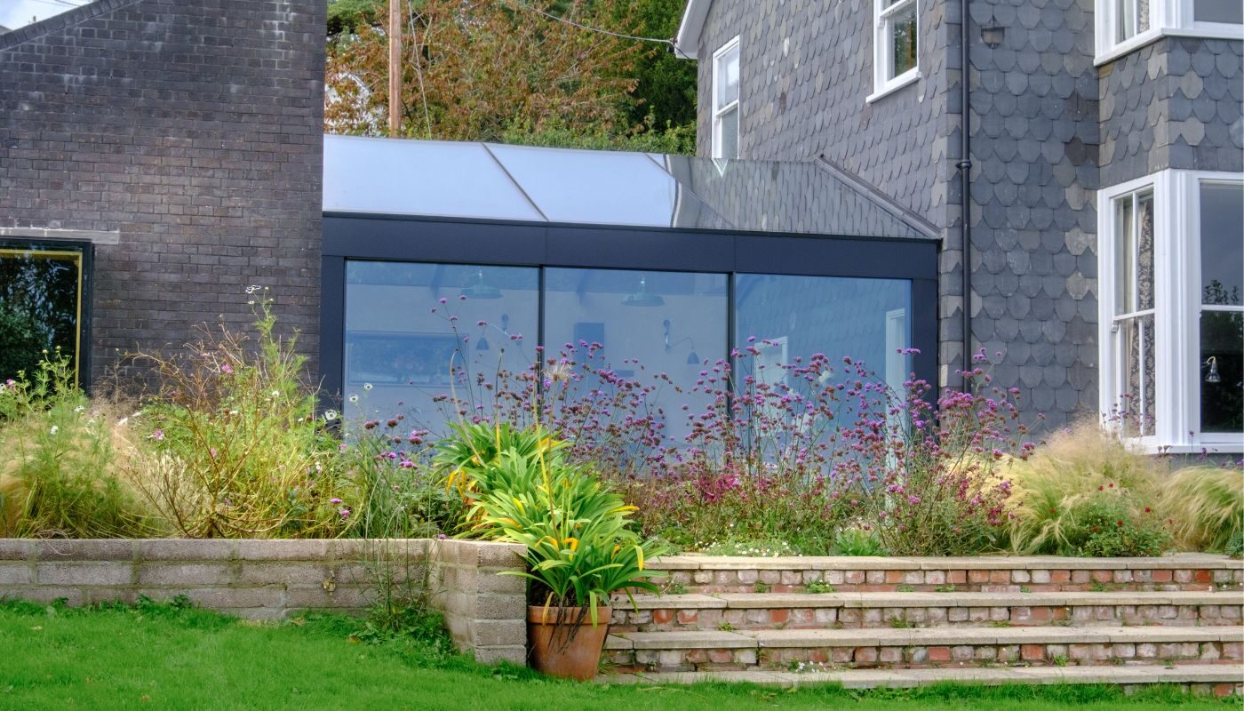 a sloped roof glass extension in lyme regis shown from the outside