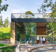 frameless sliding glass doors to the front of the story of gardening museum in somerset with people in front of the doors shown part open
