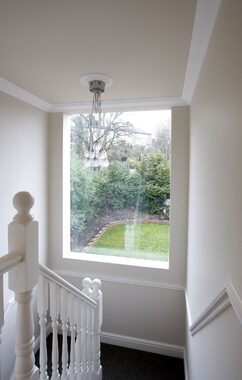 loft extension staircase with frameless window