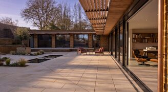 an internal courtyard of a passive house showing the frameless glazing around the elevations of the building.