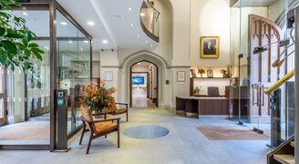an internal view of the reception area at the pitt building in cambridge showing the glass draft lobbies