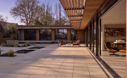 an internal courtyard of a passive house showing the frameless glazing around the elevations of the building.