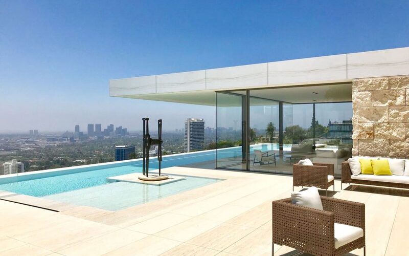 LA modern home with frameless descending windows by outdoor pool