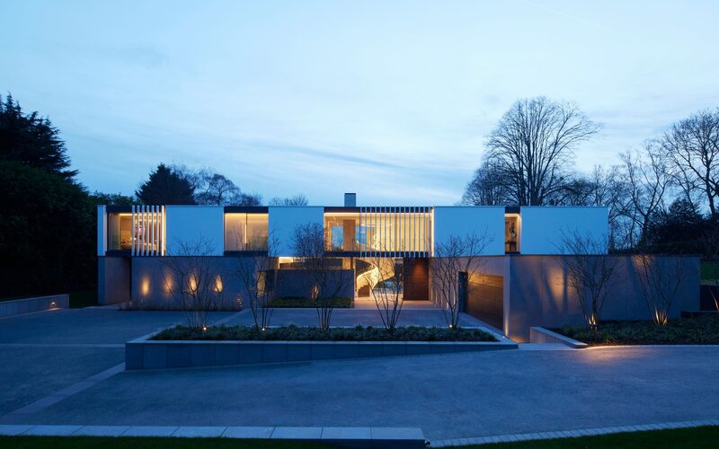 A contemporary home in radlett shown from the front elevation at dusk