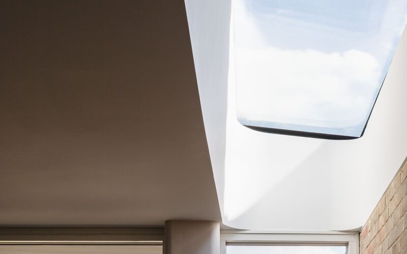 a strip rooflight with a curved edge, a close up image from the underside of a frameless rooflight