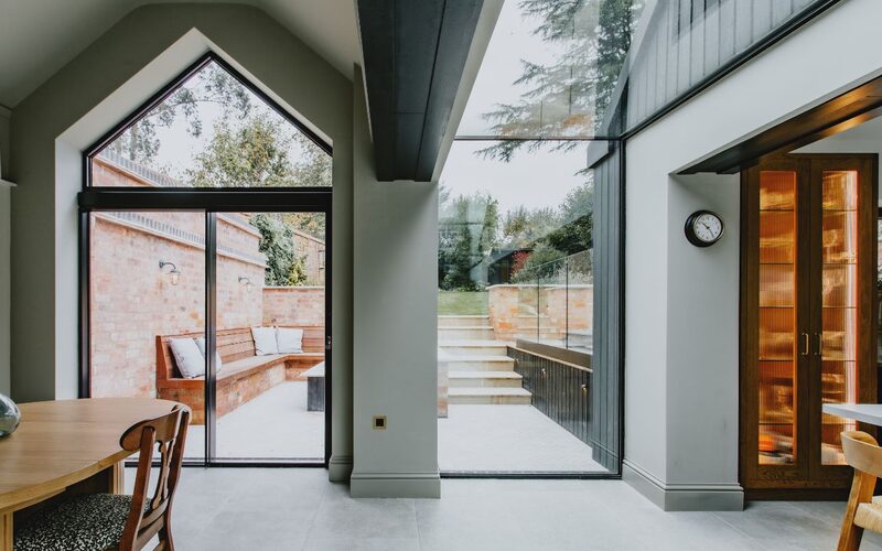 a gable window to a dining roof with a frameless glass window and link next to it