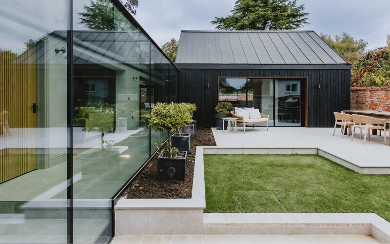 looking along the outside of a frameless glass link showing the sheer and frameless elevation of glass