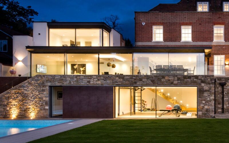a double height glazed extension in totteridge using slim sliding glass doors to create the glazed walls