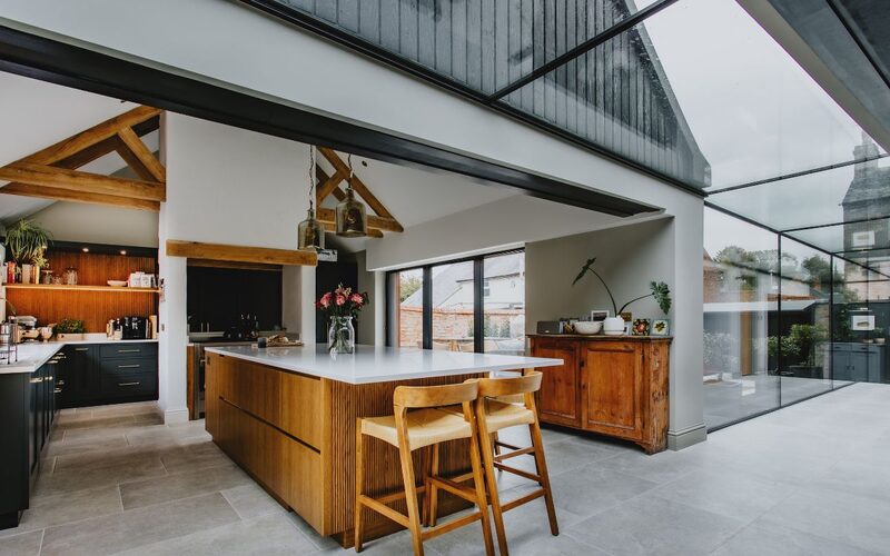 an internal view of an open plan kitchen with a strip rooflight
