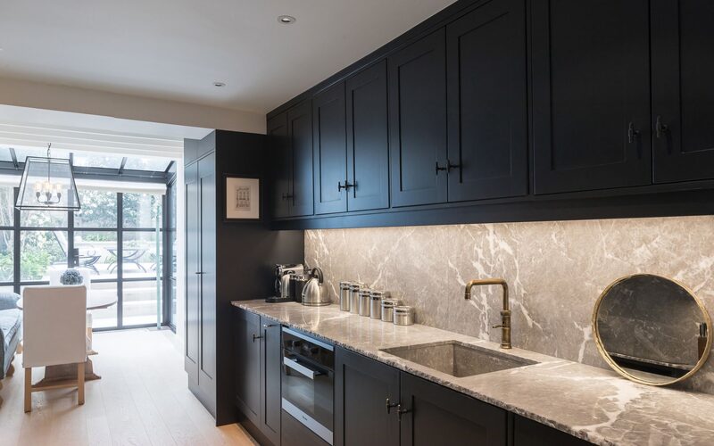 a kitchen with a luxury glass extension at the end