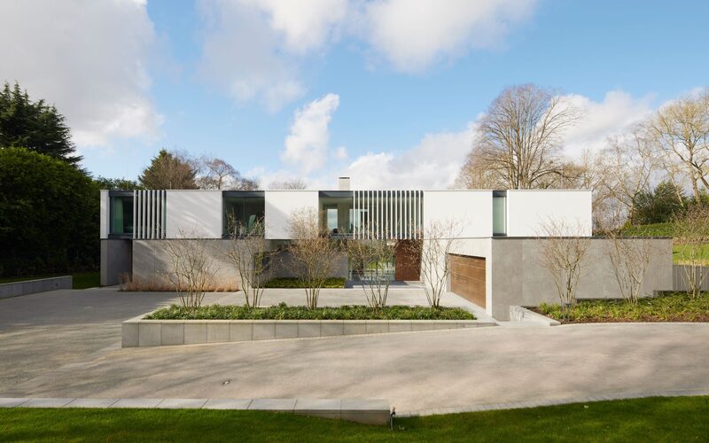 a modern house using glass and stone on a private street in radlett