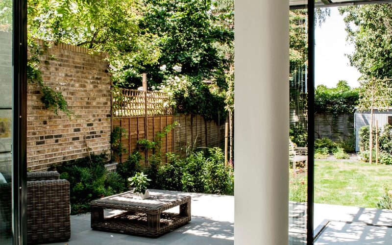 open corner sliding doors to a rear modern extension in London