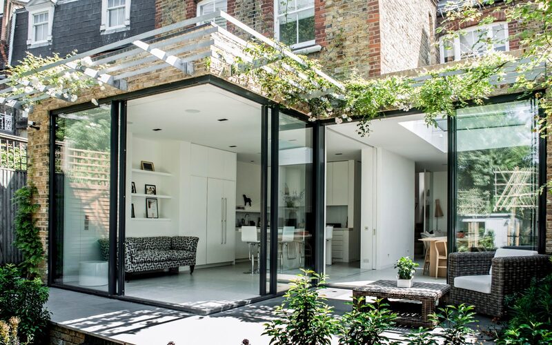 a rear extension with open corner sliding doors shown open from the outside