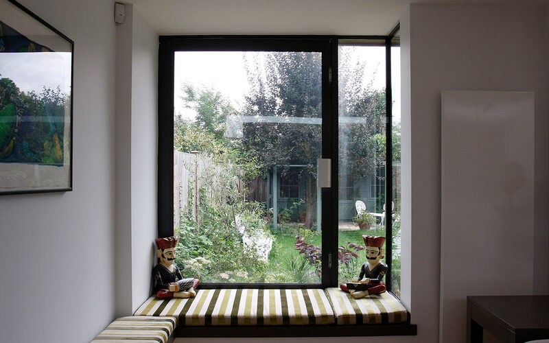Oriel window with a cushioned window seat and opening section at Lowther Road, London