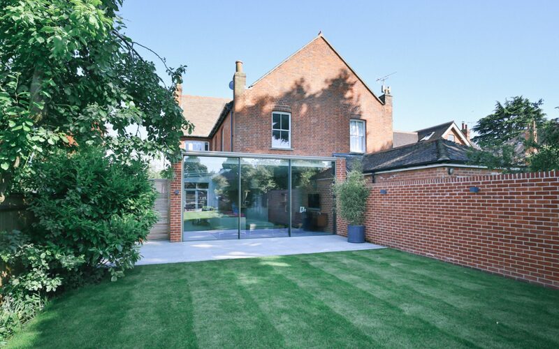 sliding glass doors to the rear of a house extension of brick