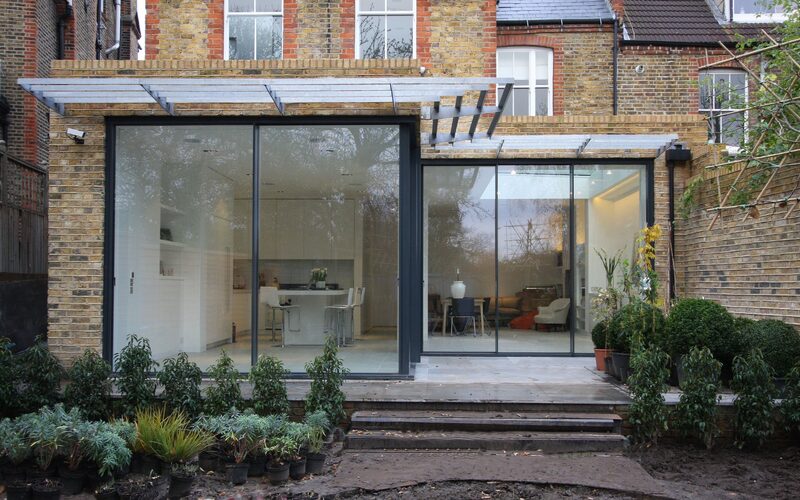 a rear extension with slim glass doors as the rear walls