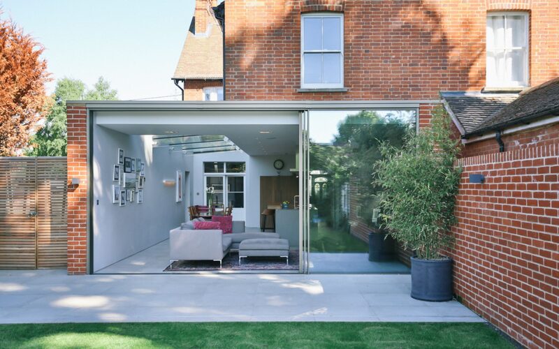 slim patio doors to the rear of a brick house extension