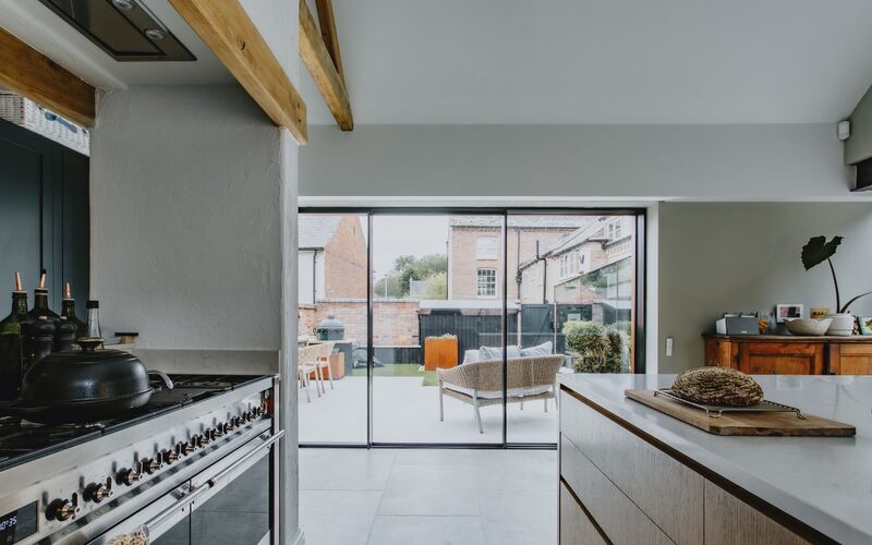 slim sliding doors to a kitchen overlooking a small courtyard