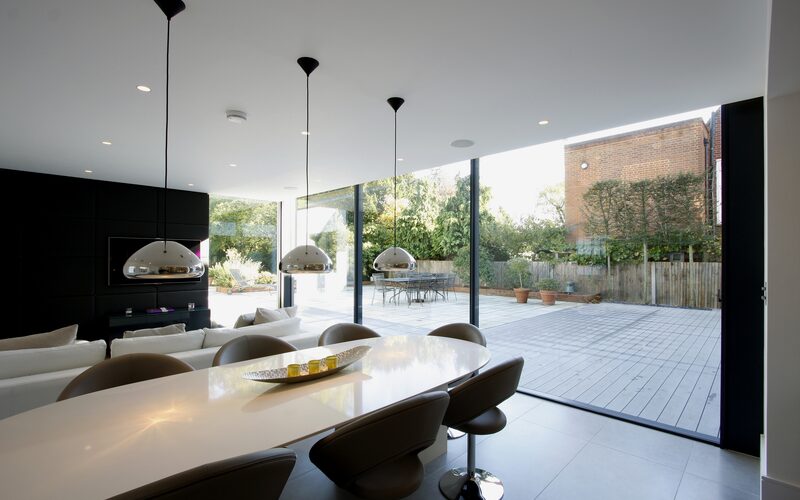 Frameless glass sliding doors to rear extension at Uphill Road | IQ Glass