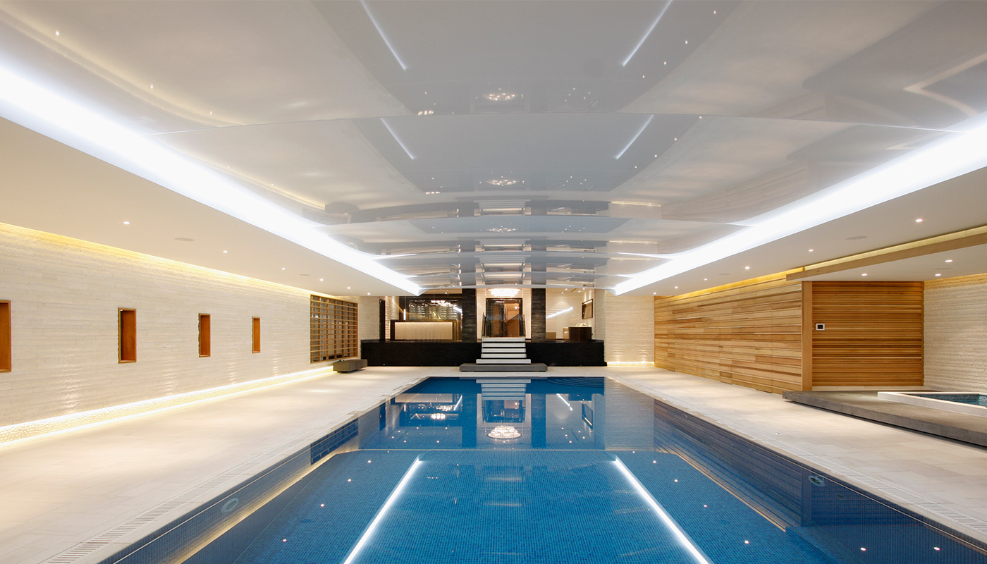 Luxury indoor swimming pool demonstrating glazing for specialist wellness spaces, with a frameless structural glazing ceiling.
